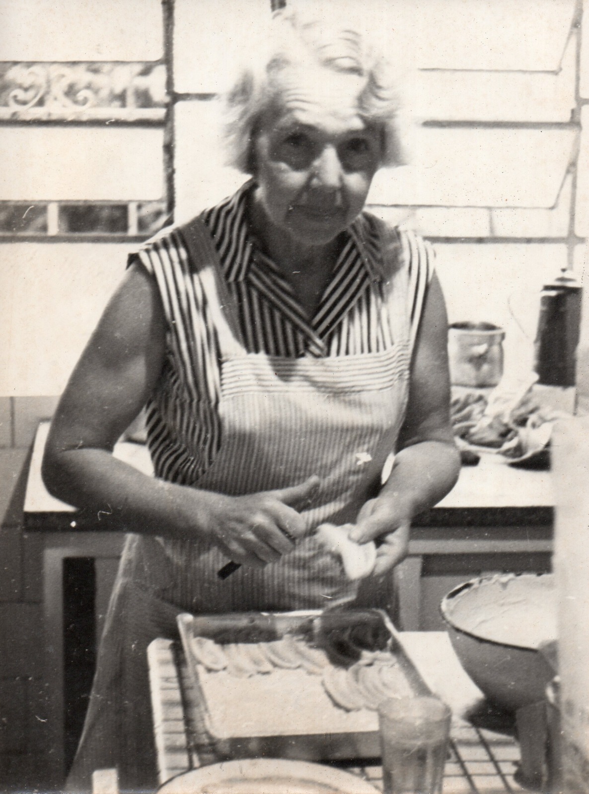 Original: my grandmother preparing her world-famous banana pie Original damaged and monochrome photo of my grandmother preparing a banana pie